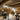 Modern fine art bartending school bar interior with tables, chairs, and shelves displaying bottles