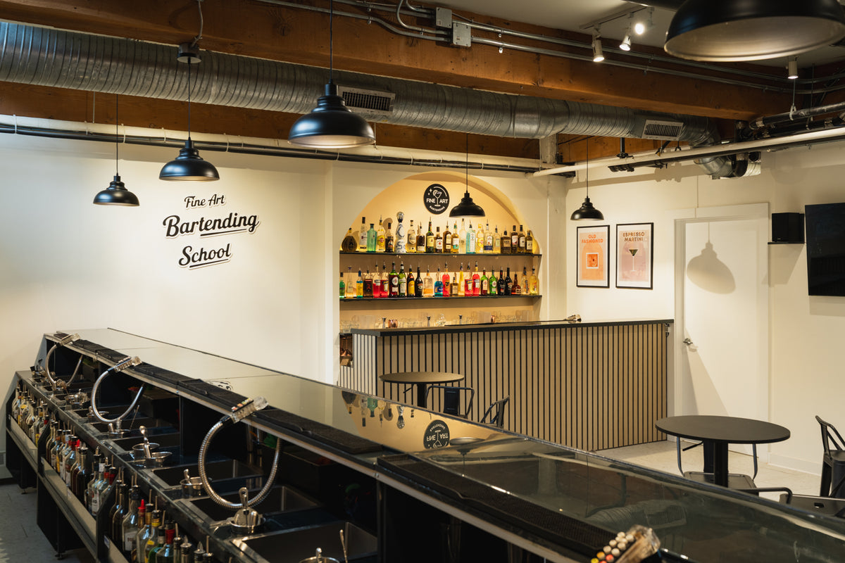 Inside Fine Art Bartending School Vancouver, showing the training bar and student stations