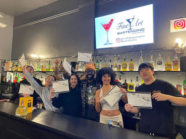 Students receiving their certificates in the classroom at the Fine Art Bartending School near Richmond, British Columbia
